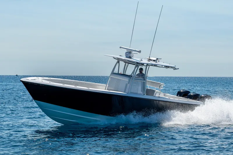 Slide: The Image of 2017 Contender 39 ST boat cruising on open water, side view. - 23