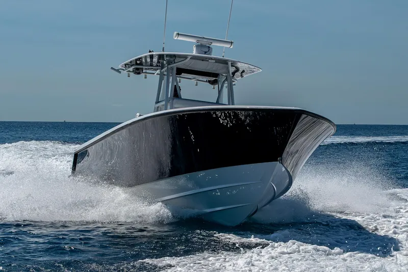 Slide: The Image of 2017 Contender 39 ST boat cruising on open water, creating waves. - 24