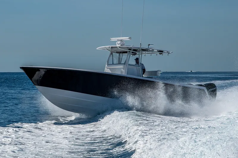 Slide: The Image of 2017 Contender 39 ST boat cruising on open water, creating a dynamic wake. - 26