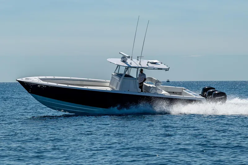 Slide: The Image of 2017 Contender 39 ST boat cruising on open water, side view. - 27