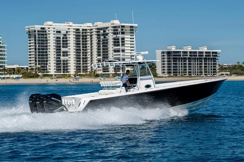 Slide: The Image of 2017 Contender 39 ST boat cruising on water with cityscape background. - 35