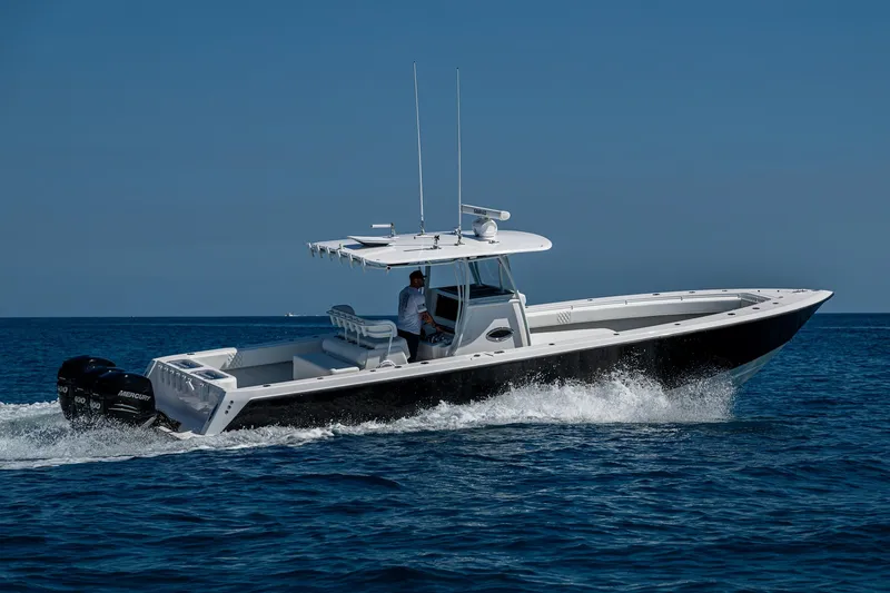 Slide: The Image of 2017 Contender 39 ST boat cruising on open water under clear blue sky. - 36