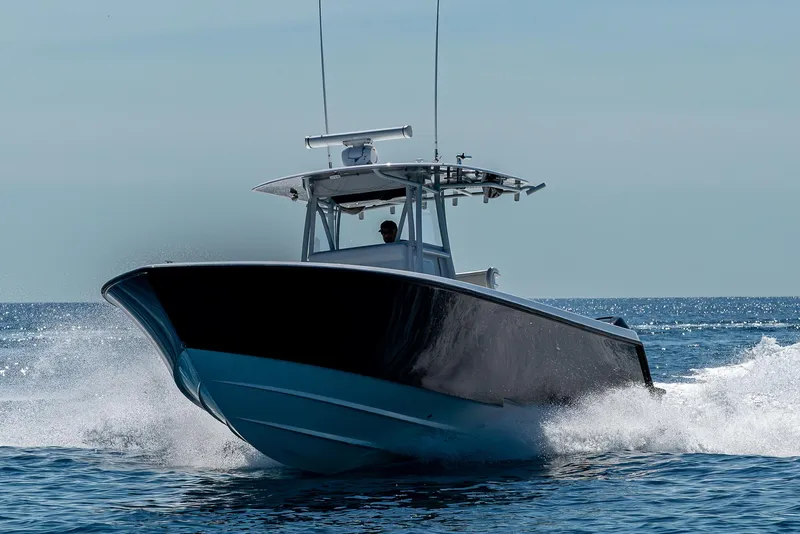 Slide: The Image of 2017 Contender 39 ST boat cruising on open water, creating a splash. - 39