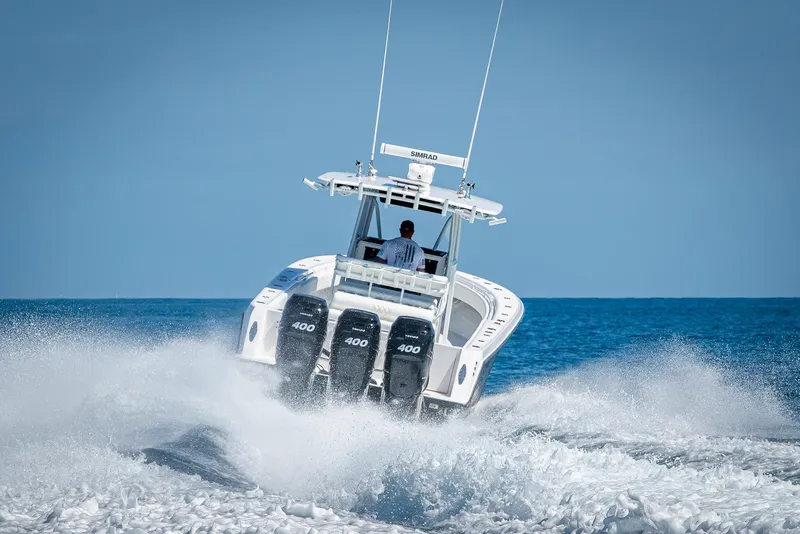 Slide: The Image of 2017 Contender 39 ST boat speeding on open water with triple 400 engines. - 42