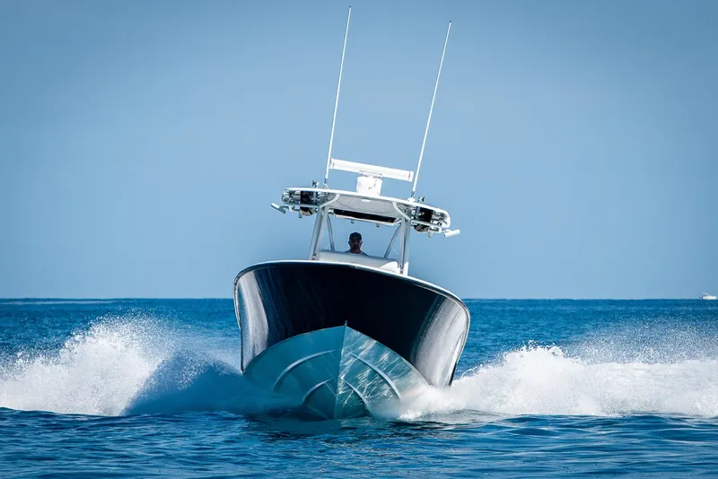 Slide: The Image of 2017 Contender 39 ST boat cruising on open water, creating a splash. - 43