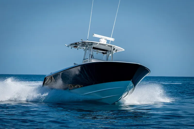 Slide: The Image of 2017 Contender 39 ST boat cruising on open water, creating a splash. - 44