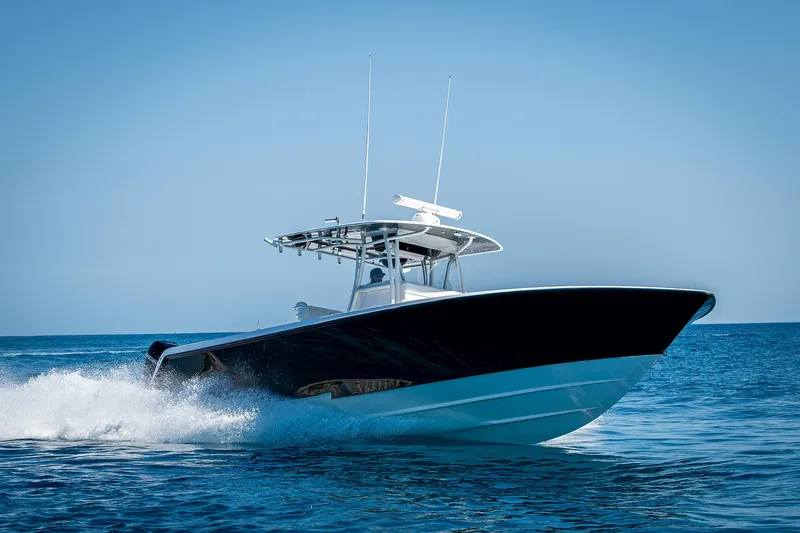 Slide: The Image of 2017 Contender 39 ST boat cruising on open water under clear blue sky. - 45