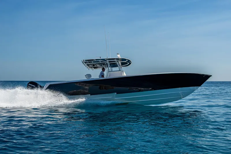 Slide: The Image of 2017 Contender 39 ST boat cruising on open water under clear blue sky. - 46