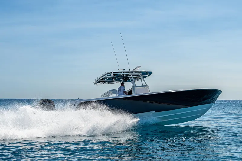 Slide: The Image of 2017 Contender 39 ST boat cruising on open water, creating a splash. - 47