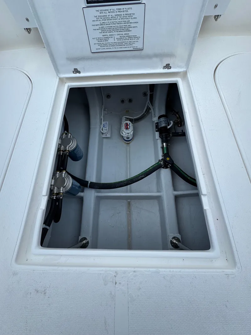 Slide: The Image of 2025 NorthCoast 255 HT boat compartment with visible wiring and components. - 15