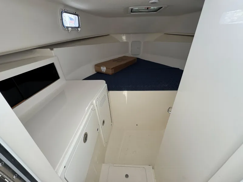 Slide: The Image of 2025 NorthCoast 255 HT cabin interior with storage and compact design. - 18