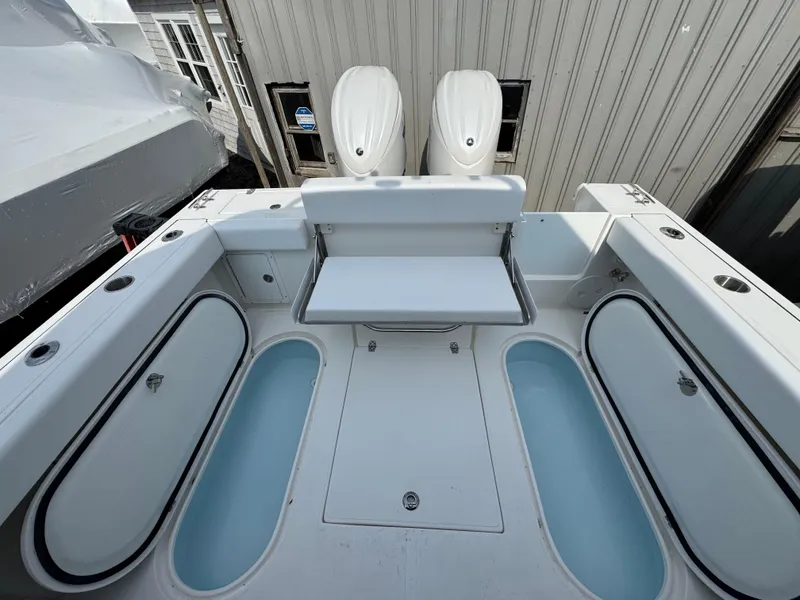 Slide: The Image of 2025 NorthCoast 255 HT boat deck with seating and storage compartments. - 7