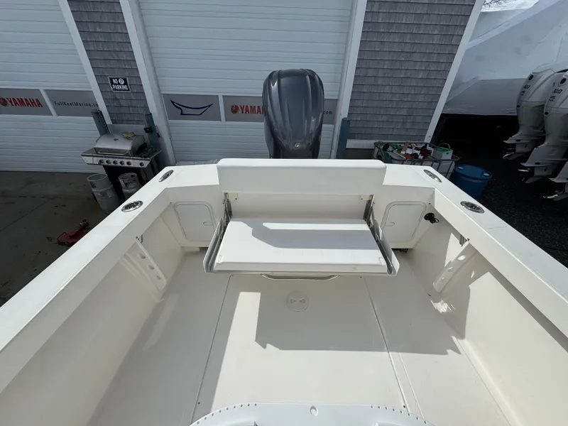 Slide: The Image of 2025 NorthCoast 230 Center Console boat interior with seating and storage compartments. - 10