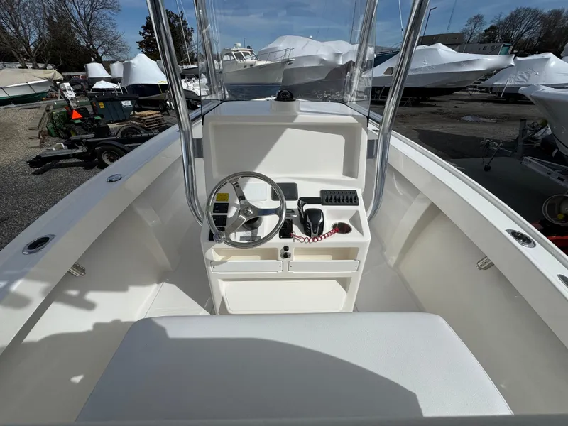 Slide: The Image of 2025 NorthCoast 230 Center Console boat interior with steering wheel and controls. - 7
