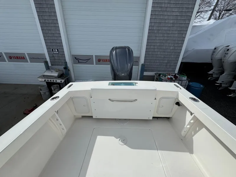 Slide: The Image of 2025 NorthCoast 230 Center Console boat interior with Yamaha engine in a garage setting. - 9