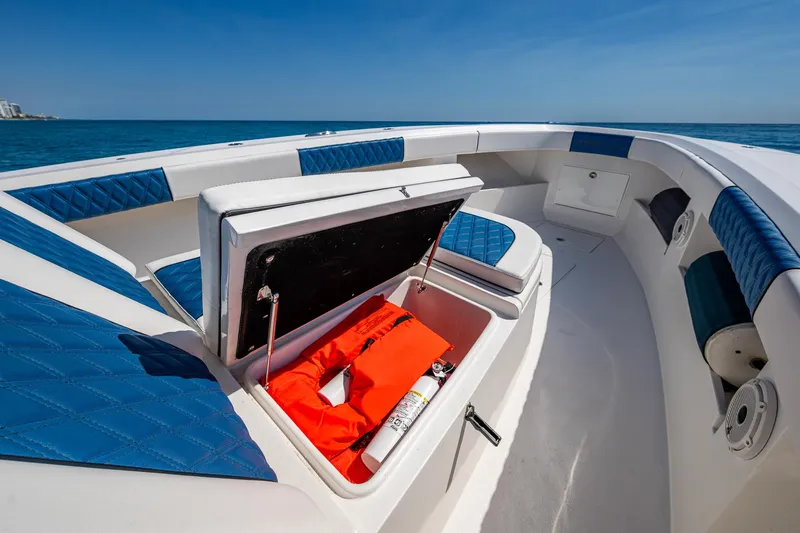Slide: The Image of Front Runner 39 boat interior with open storage, life jacket, and blue seating, 2020 model. - 10