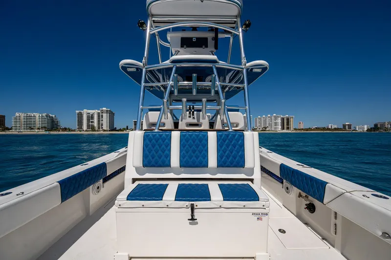 Slide: The Image of Front Runner 39 boat, 2020 model, with blue seating, on water near city skyline. - 16