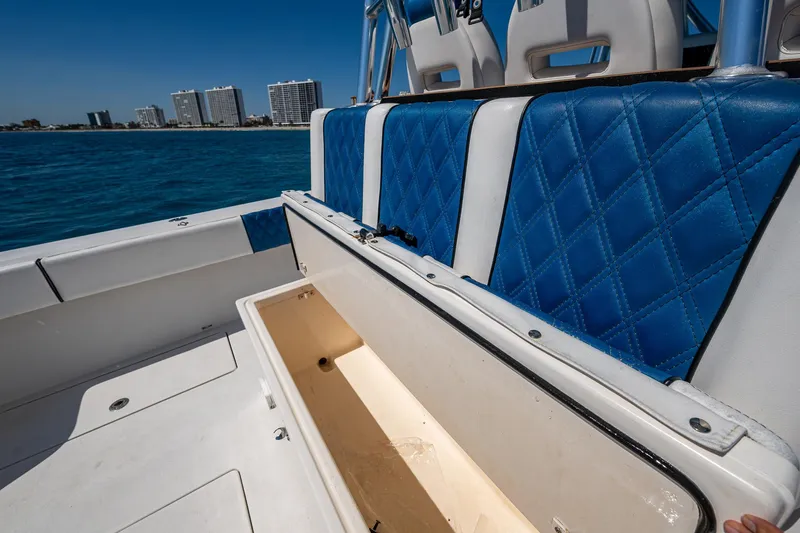 Slide: The Image of 2020 Front Runner 39 boat interior with blue seating and open storage compartment. - 19