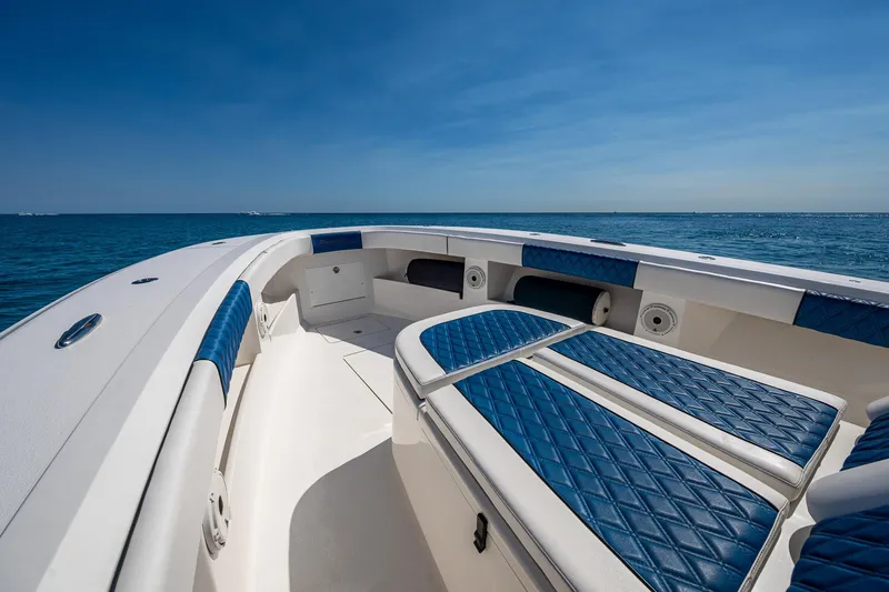 Slide: The Image of 2020 Front Runner 39 boat with blue seating, ocean view, clear sky. - 2