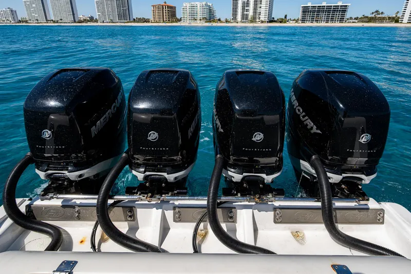 Slide: The Image of Four Mercury outboard engines on a 2020 Front Runner 39 boat, with city skyline in background. - 21