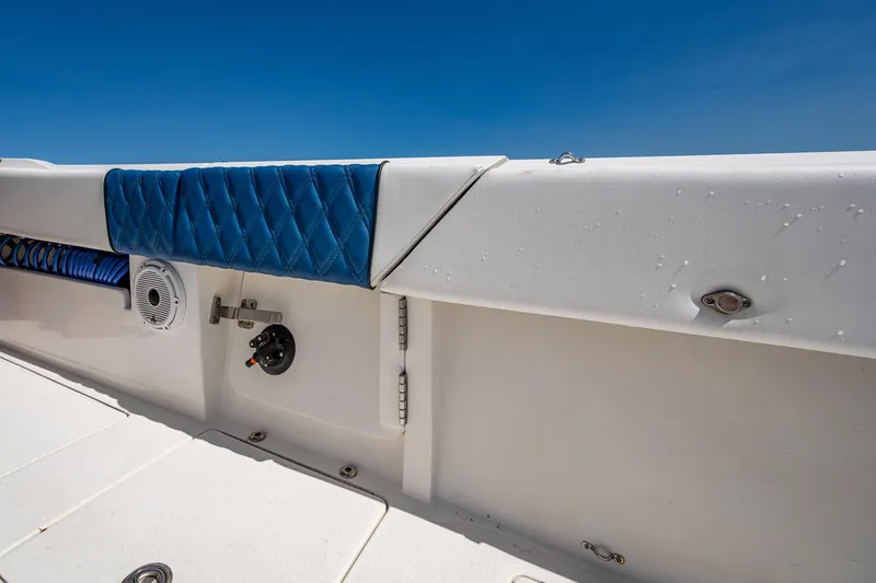 Slide: The Image of 2020 Front Runner 39 boat interior with blue cushioned seating and white deck. - 23