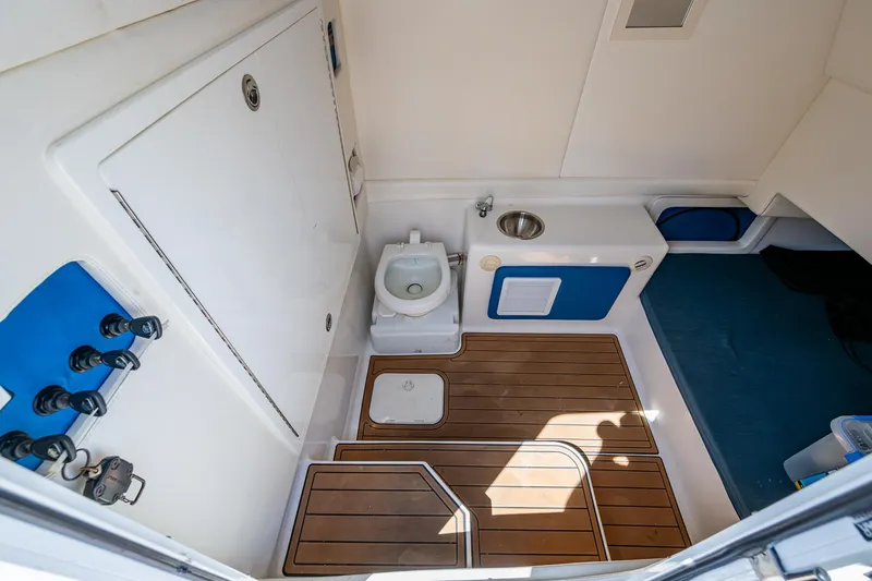 Slide: The Image of Interior of 2020 Front Runner 39 boat bathroom with wooden flooring and compact design. - 24