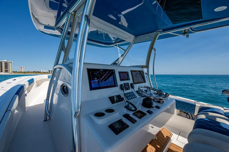 Slide: The Image of 2020 Front Runner 39 boat cockpit with navigation equipment, steering wheel, and ocean view. - 31