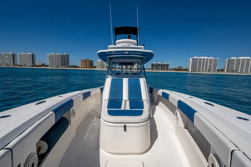 Slide: The Image of Front Runner 39 boat, 2020 model, cruising on clear blue water with city skyline backdrop. - 7