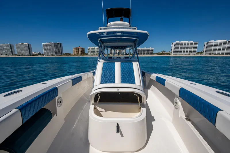 Slide: The Image of 2020 Front Runner 39 boat with blue accents, docked near waterfront buildings. - 9