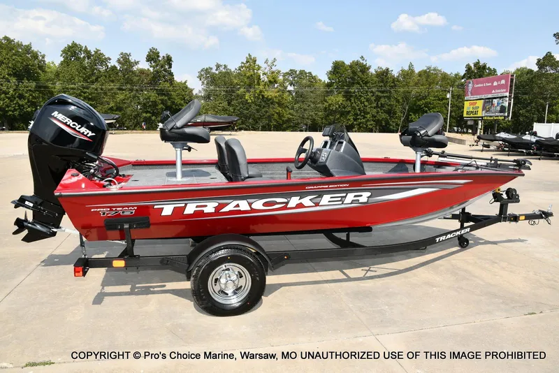Slide: The Image of 2025 Tracker Pro Team 175 Crappie Edition boat, red, parked outdoors on a trailer. - 18