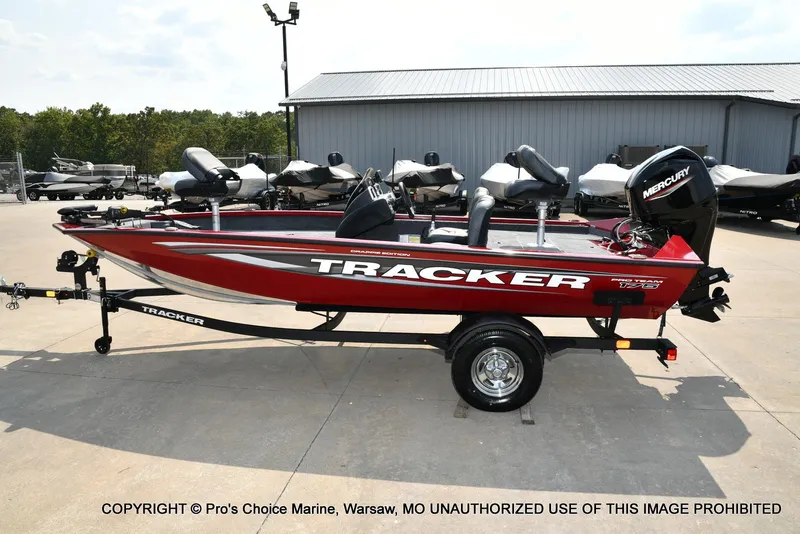 Slide: The Image of 2025 Tracker Pro Team 175 Crappie Edition boat, red, on trailer, parked outdoors. - 22