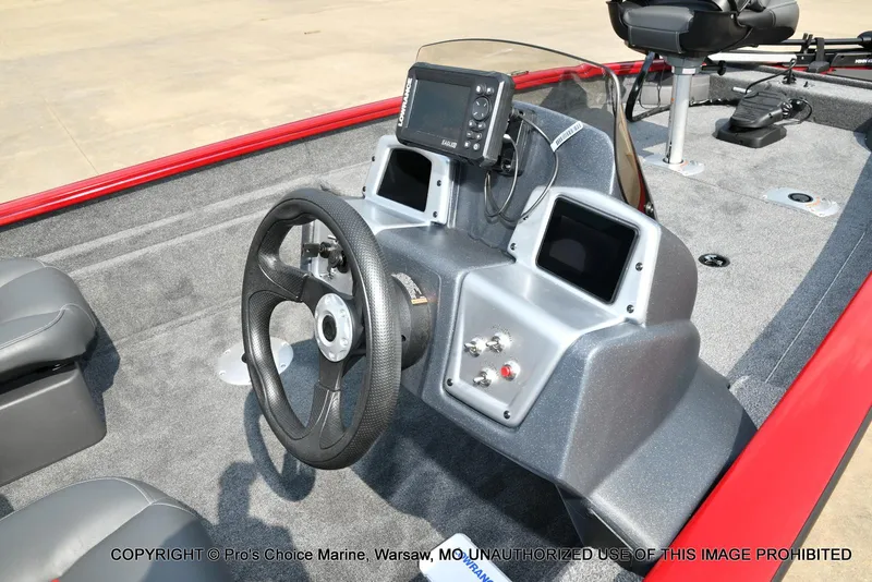 Slide: The Image of 2025 Tracker Pro Team 175 Crappie Edition boat interior with steering wheel and control panel. - 32