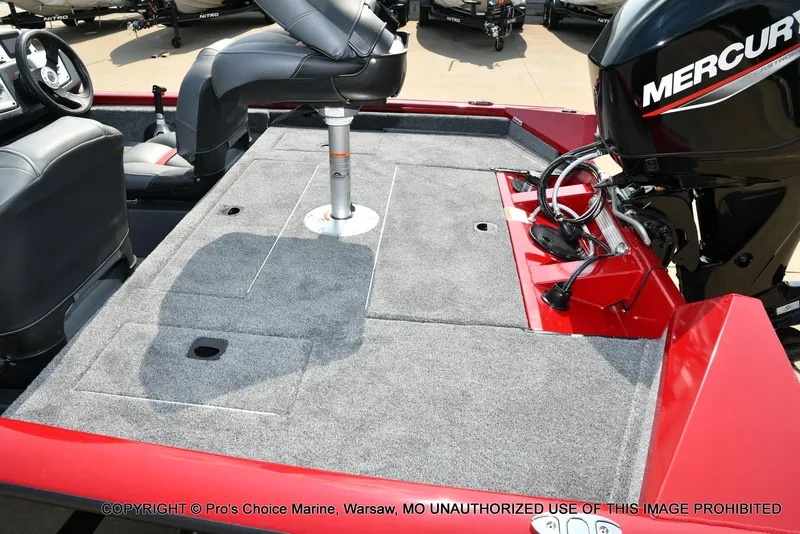 Slide: The Image of 2025 Tracker Pro Team 175 Crappie Edition boat interior with Mercury engine, gray carpet, and seating. - 34