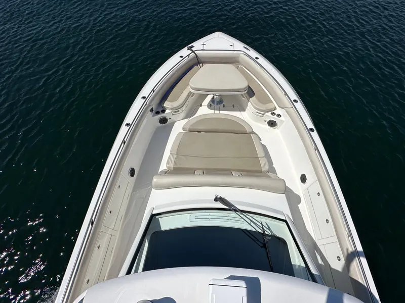 Slide: The Image of 2020 Boston Whaler 420 Outrage boat, aerial view of bow seating area on water. - 17