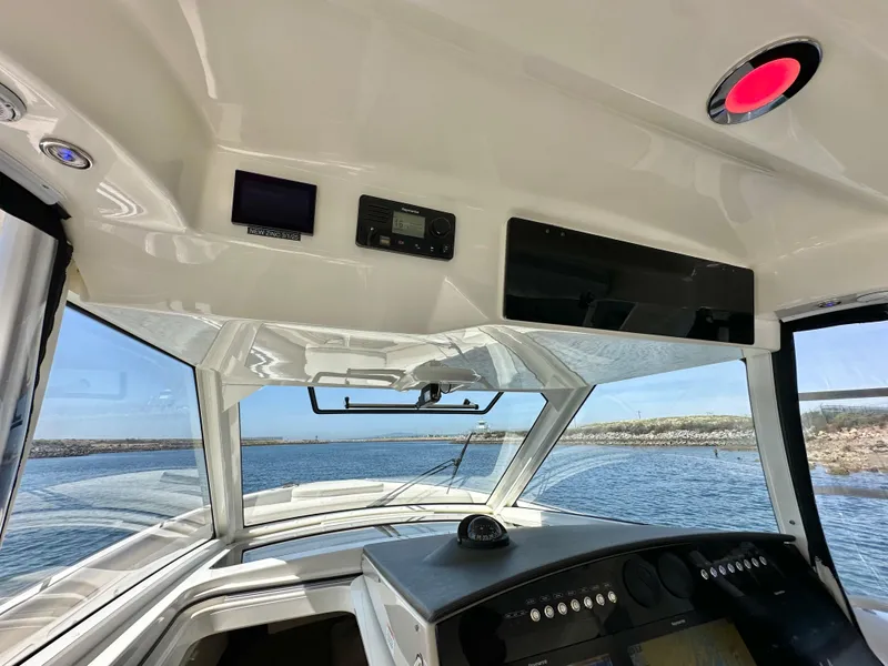 Slide: The Image of Interior view of 2020 Boston Whaler 420 Outrage boat cockpit with ocean backdrop. - 19