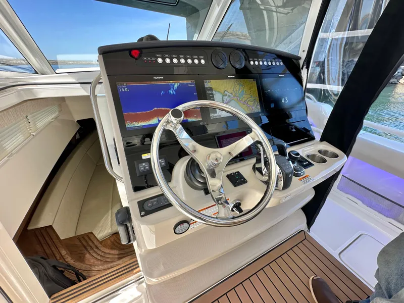 Slide: The Image of 2020 Boston Whaler 420 Outrage helm with advanced navigation displays and steering wheel. - 20