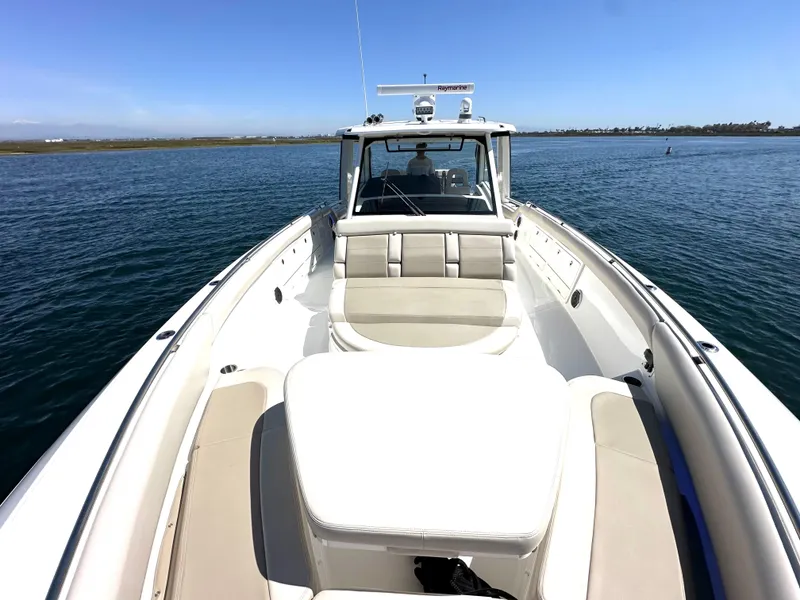 Slide: The Image of 2020 Boston Whaler 420 Outrage boat on calm water, featuring spacious seating and sleek design. - 23