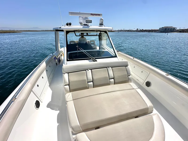 Slide: The Image of 2020 Boston Whaler 420 Outrage boat on calm water, featuring spacious seating and modern design. - 25