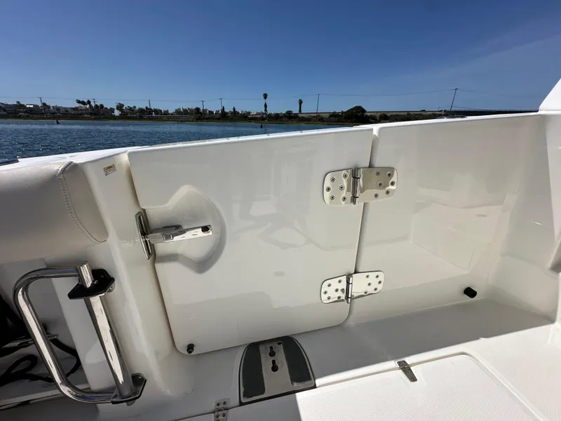 Slide: The Image of 2020 Boston Whaler 420 Outrage boat deck with white hatch and stainless steel hardware. - 31