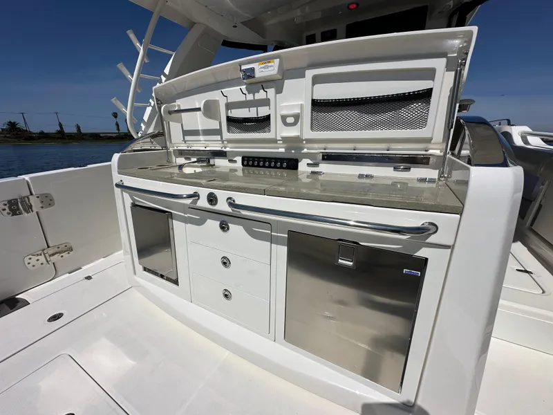 Slide: The Image of 2020 Boston Whaler 420 Outrage boat deck with sleek storage and utility area. - 33