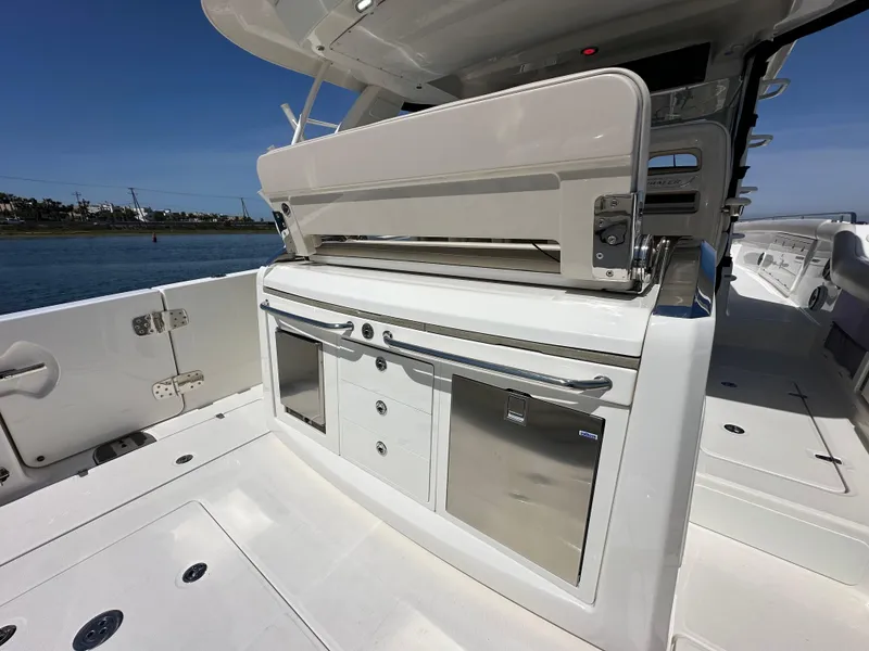 Slide: The Image of 2020 Boston Whaler 420 Outrage boat interior with sleek kitchen amenities and storage. - 34