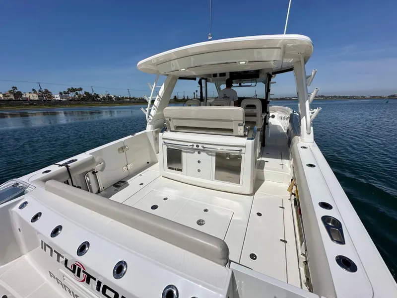 Slide: The Image of 2020 Boston Whaler 420 Outrage boat, spacious deck, luxury seating, and modern design on calm water. - 36
