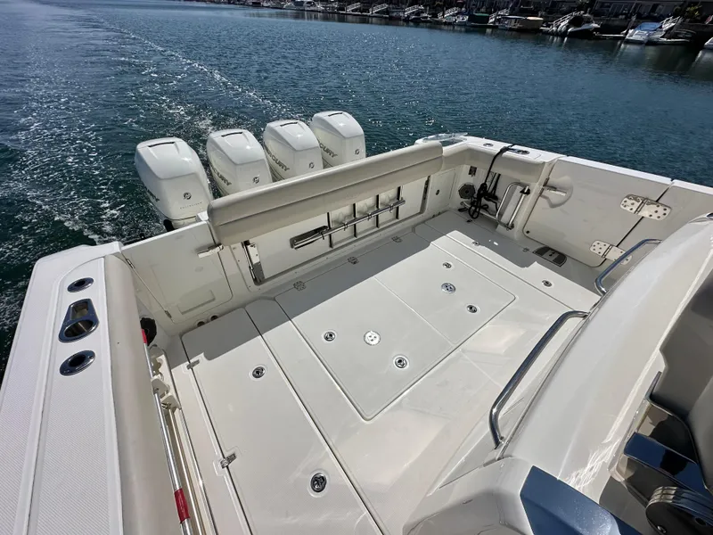 Slide: The Image of 2020 Boston Whaler 420 Outrage boat deck with four engines, on calm water. - 37
