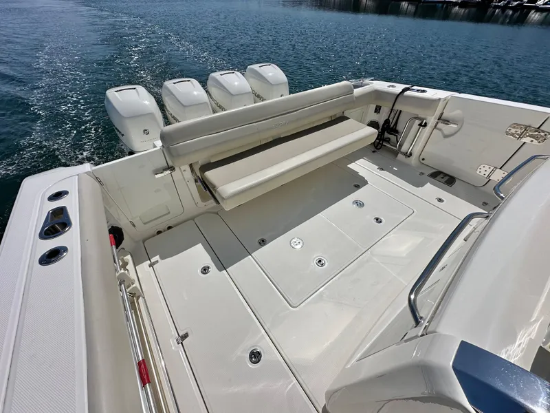 Slide: The Image of 2020 Boston Whaler 420 Outrage boat deck with seating and four engines. - 38