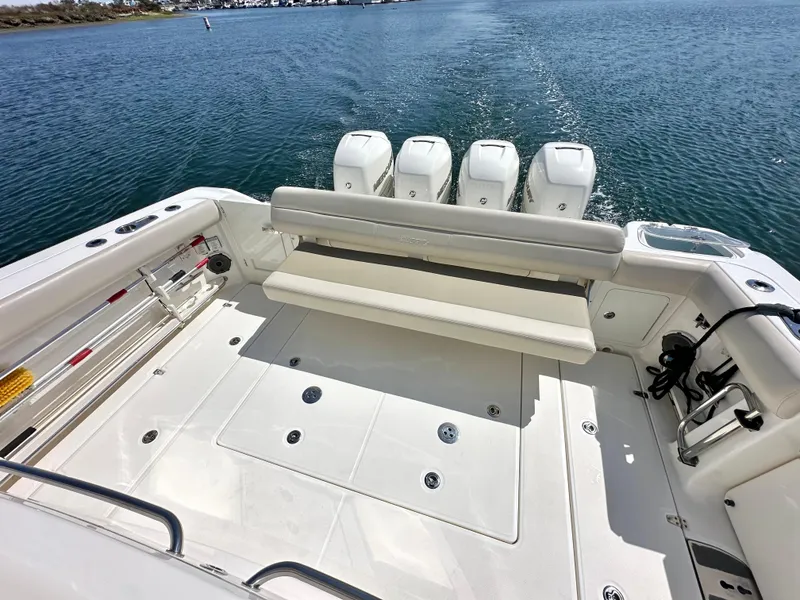 Slide: The Image of 2020 Boston Whaler 420 Outrage boat with spacious deck and four engines on open water. - 39
