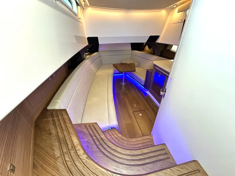 Slide: The Image of 2020 Boston Whaler 420 Outrage interior with elegant seating, ambient lighting, and wooden accents. - 41