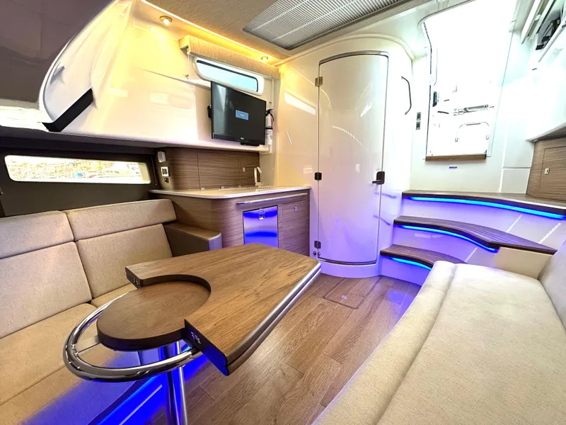 Slide: The Image of Luxurious interior of 2020 Boston Whaler 420 Outrage with modern seating and ambient lighting. - 43