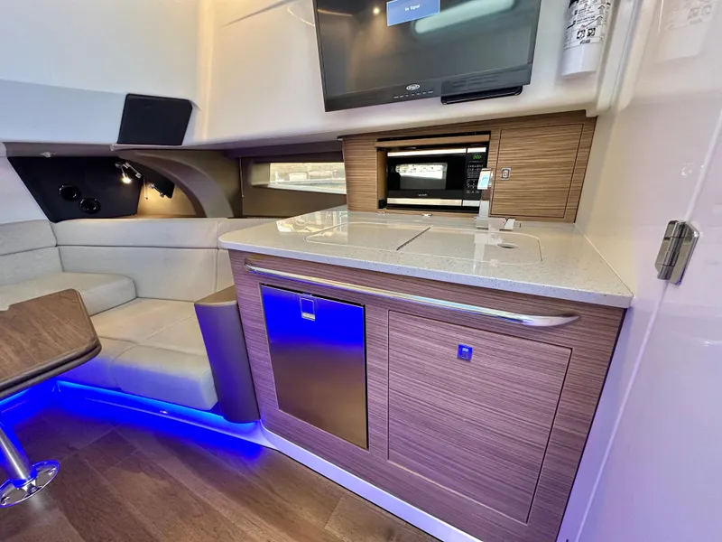 Slide: The Image of Luxurious interior of 2020 Boston Whaler 420 Outrage with modern kitchenette and seating area. - 45