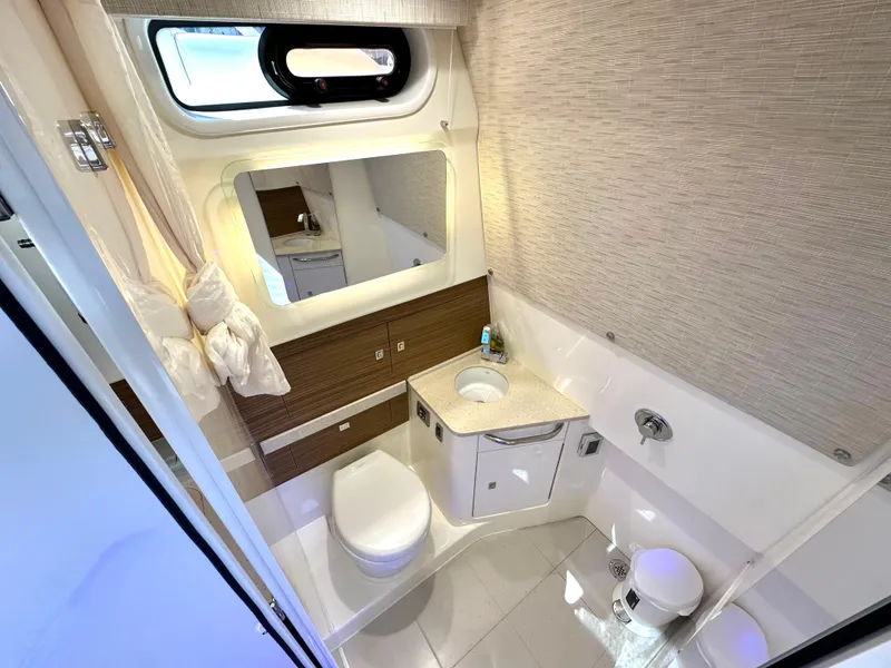 Slide: The Image of 2020 Boston Whaler 420 Outrage bathroom with modern fixtures and window. - 49