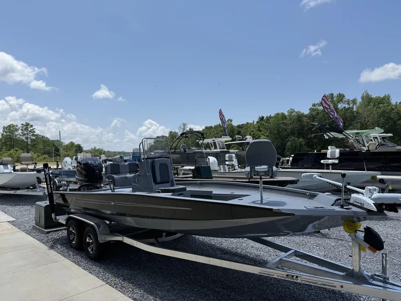 Slide: The Image of 2025 Xpress Hyper-Lift Series H22B boat on trailer, parked outdoors under clear sky. - 1